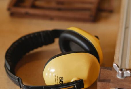 Noise-Canceling Headphones - Protective headphones for woodwork on wooden table
