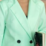 Smartphone Accessories - A Woman in Green Blazer Standing Inside the Office