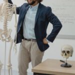 Standing Desks - Man Standing beside a Human Skeleton
