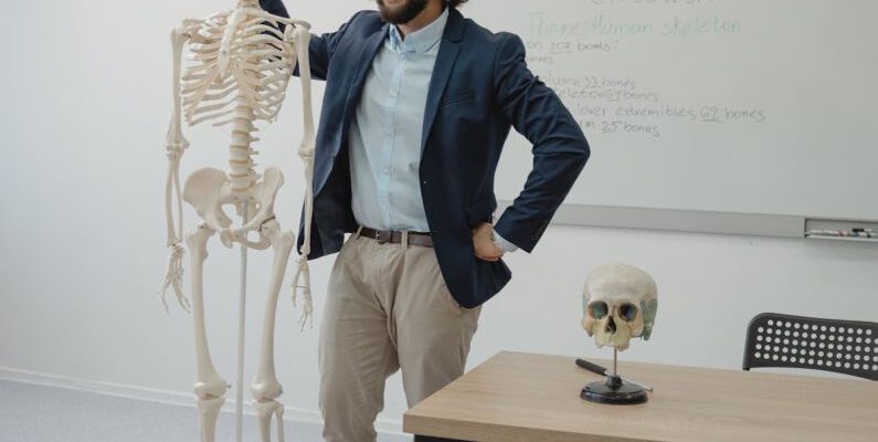 Standing Desks - Man Standing beside a Human Skeleton