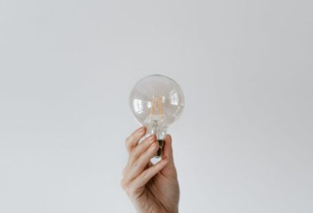 Smart Lighting - Anonymous female showing light bulb