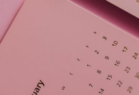 Monthly Subscriptions - Top view of contemporary paper agenda with calendar representing dates and months on desk