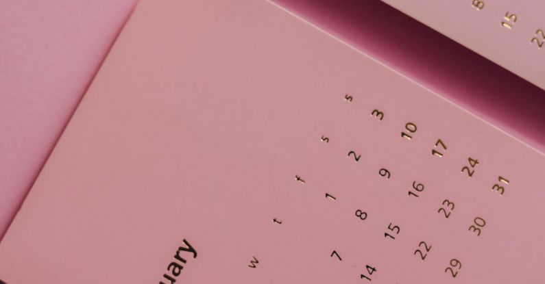 Monthly Subscriptions - Top view of contemporary paper agenda with calendar representing dates and months on desk