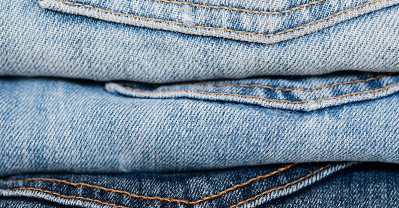 Quality Clothes - Stack of blue jeans arranged by color