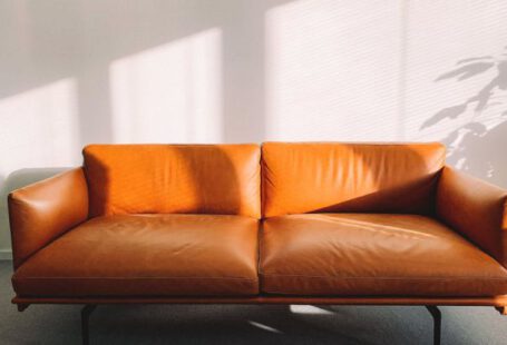 Sofa - 2-seat Orange Leather Sofa Beside Wall