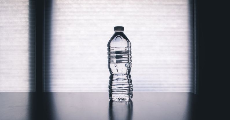 Water Bottle - Clear Disposable Bottle on Black Surface